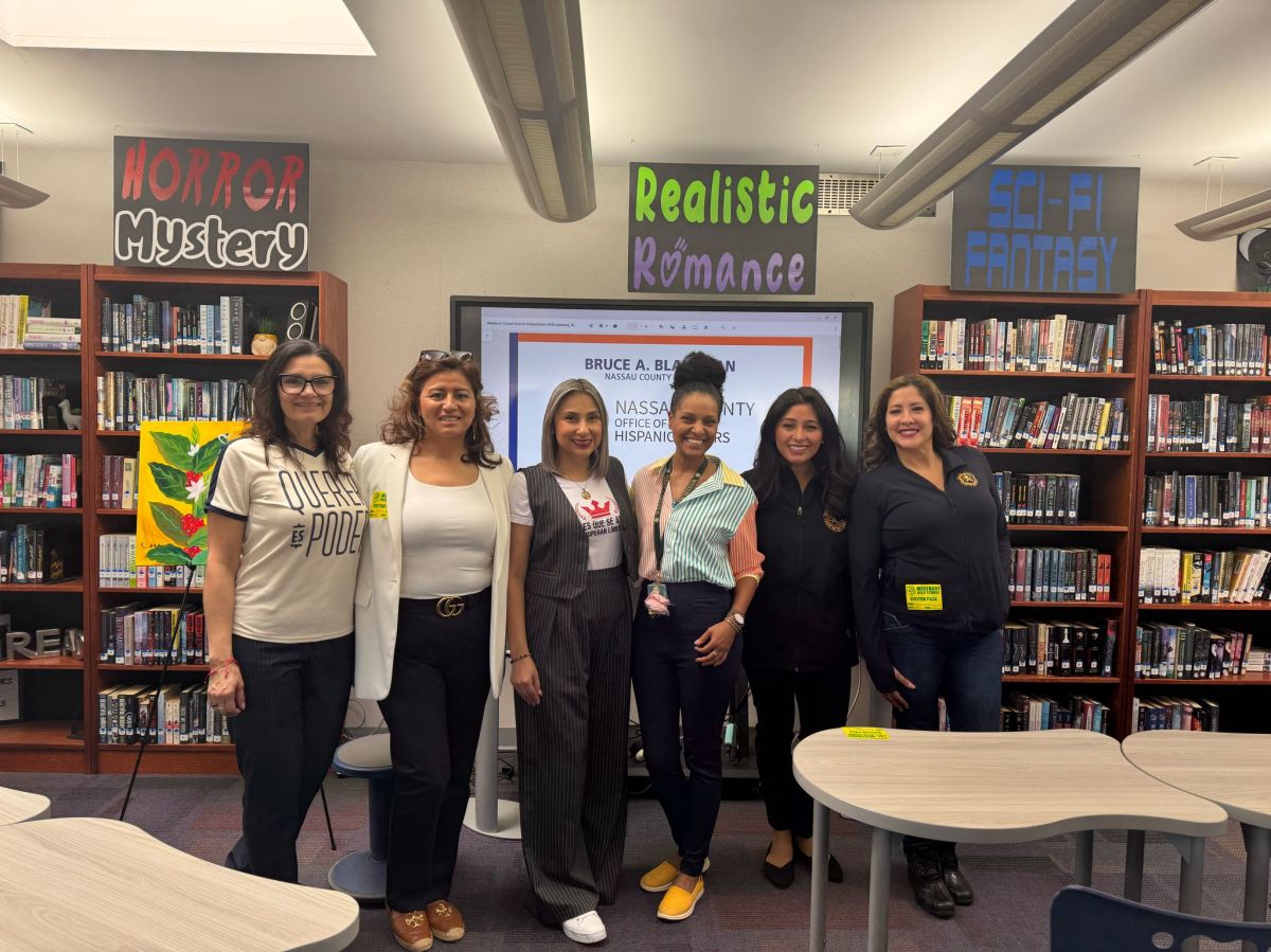 Westbury High School World Language Chairperson Shirley Vargas with authors Sasha Quintanilla, Elvia Sanchez, Adriana Devers, Estefany Ruiz and Melissa Figueroa from Nassau County office of Hispanic Affairs.